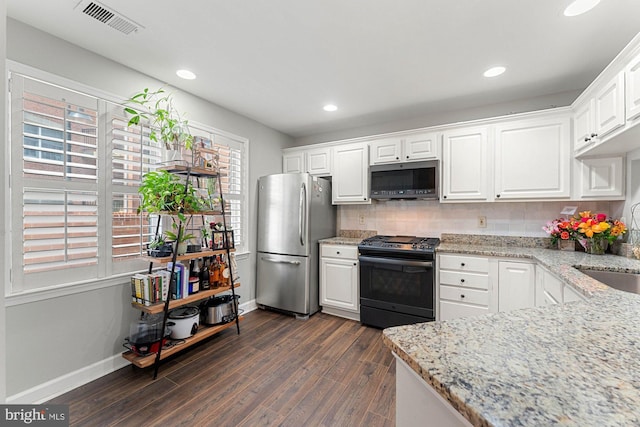 6908 Fairfax Dr Unit 202, Arlington, VA 22213 - kitchen with stainless steel appliances, dark wood-type flooring, white cabinets, backsplash, and light stone counters