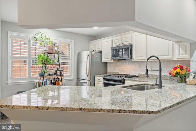 6908 Fairfax Dr Unit 202, Arlington, VA 22213 - kitchen with stainless steel appliances, light stone counters, tasteful backsplash, and white cabinetry