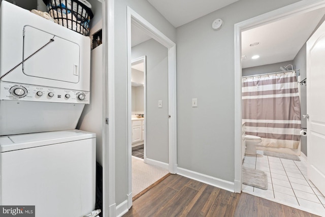 6908 Fairfax Dr Unit 202, Arlington, VA 22213 - laundry room with stacked washer / dryer and wood finished floors