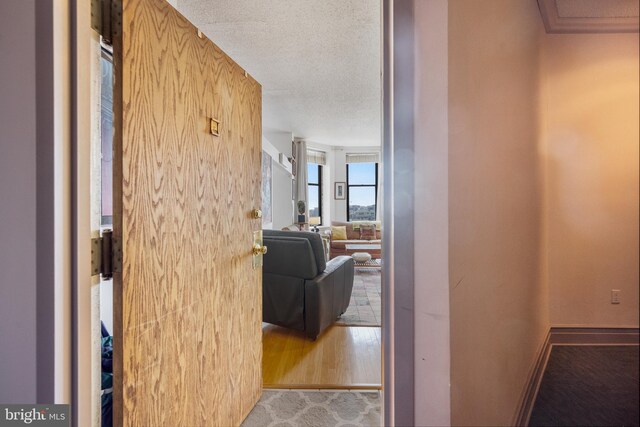 1615 Q St NW Unit 1001, Washington, DC 20009 - hallway featuring a textured ceiling and wood finished floors