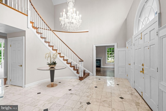 501 Van Lears Run, Villanova, PA 19085 - entrance foyer with a towering ceiling, stairs, a chandelier, and a glass covered fireplace