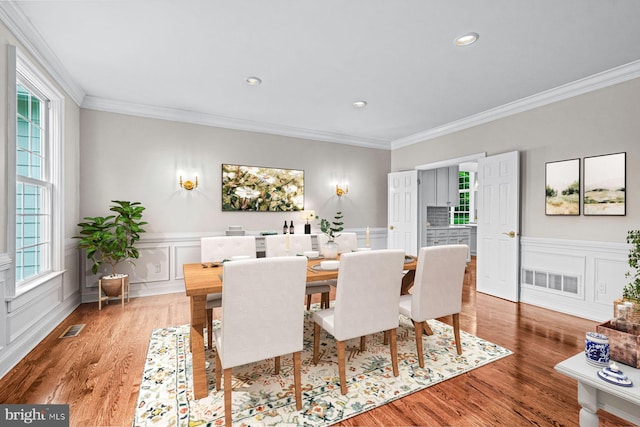 501 Van Lears Run, Villanova, PA 19085 - dining area with healthy amount of natural light, ornamental molding, wood finished floors, a decorative wall, and recessed lighting