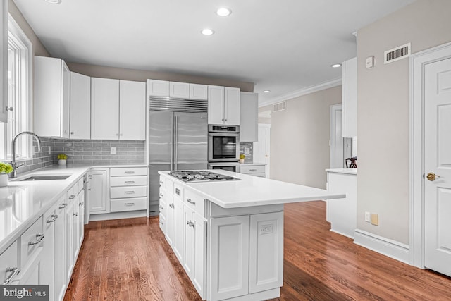501 Van Lears Run, Villanova, PA 19085 - kitchen with recessed lighting, a center island, tasteful backsplash, light countertops, and white cabinets