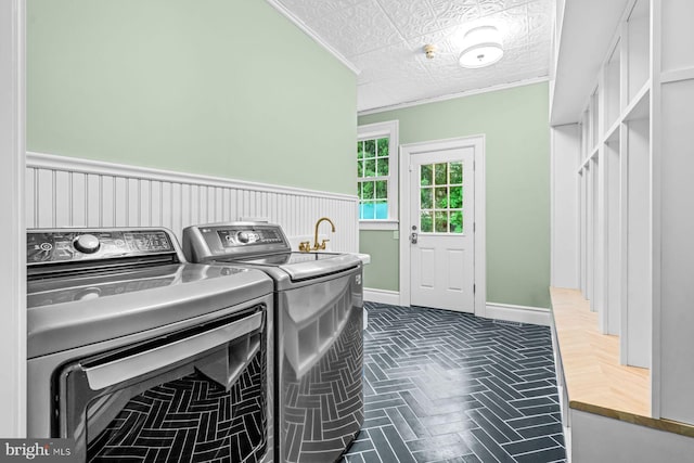 501 Van Lears Run, Villanova, PA 19085 - washroom with washer and dryer, crown molding, brick patterned flooring, and wainscoting