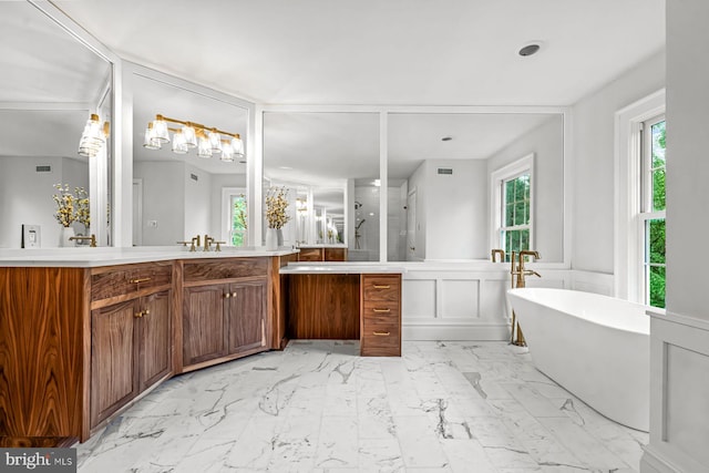 501 Van Lears Run, Villanova, PA 19085 - bathroom with vanity, a soaking tub, a wainscoted wall, marble look tile flooring, and a decorative wall