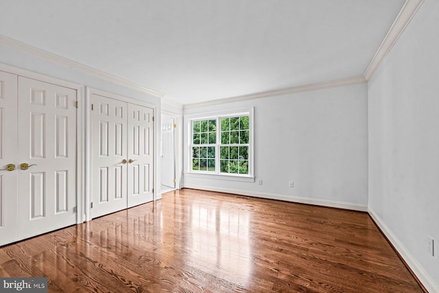 501 Van Lears Run, Villanova, PA 19085 - unfurnished bedroom with ornamental molding, wood finished floors, and two closets