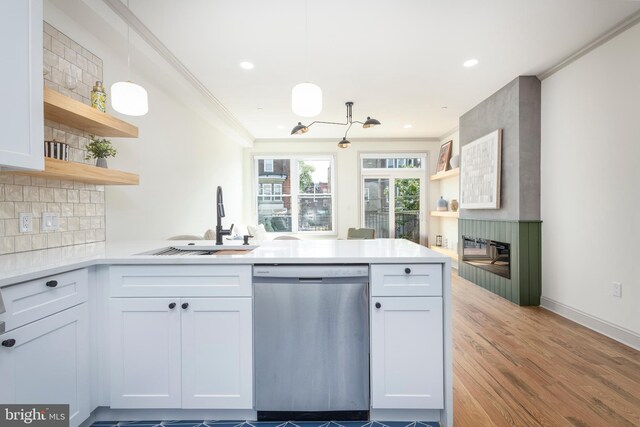 3116 Clifford St Unit 2, Philadelphia, PA 19121 - kitchen with stainless steel dishwasher, open shelves, a peninsula, tasteful backsplash, and crown molding