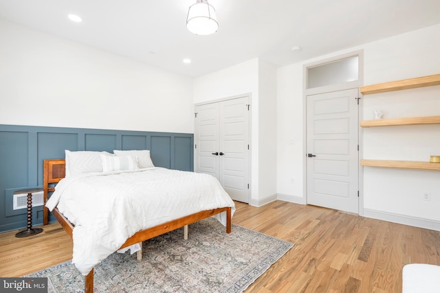 3116 Clifford St Unit 2, Philadelphia, PA 19121 - bedroom with light wood finished floors, a decorative wall, a closet, and a wainscoted wall