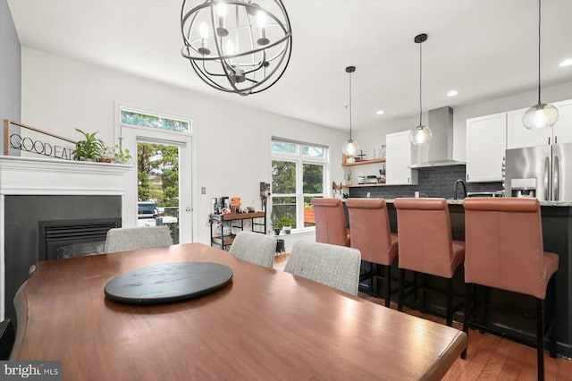 1506 Stack St, Baltimore, MD 21230 - dining space featuring a chandelier, wood finished floors, a glass covered fireplace, and recessed lighting