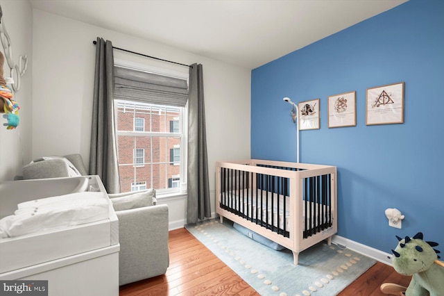 1506 Stack St, Baltimore, MD 21230 - bedroom with wood finished floors and a crib