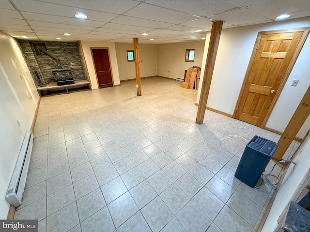 751 Hudson Dr, Weatherly, PA 18255 - finished basement featuring a wood stove, a baseboard heating unit, light tile patterned floors, a drop ceiling, and recessed lighting
