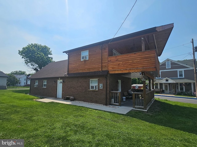 6 Amelia St, Paw Paw, WV 25434 - back of property featuring a lawn, a balcony, brick siding, and a patio area