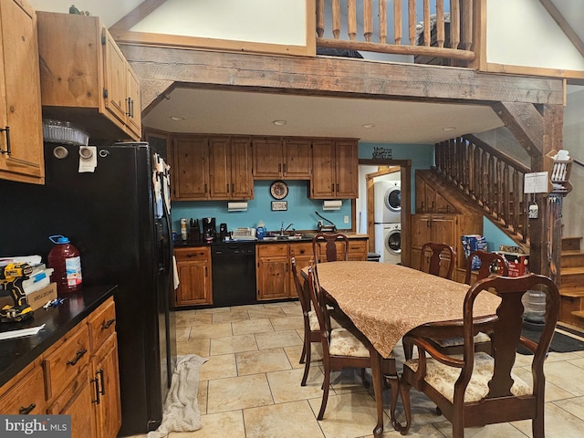 6 Amelia St, Paw Paw, WV 25434 - kitchen with stacked washer / drying machine, black appliances, dark countertops, and brown cabinets