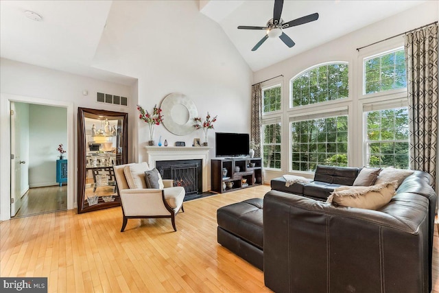 926 Kenmara Dr, West Chester, PA 19380 - living area with high vaulted ceiling, a ceiling fan, light wood-style floors, and a fireplace with flush hearth