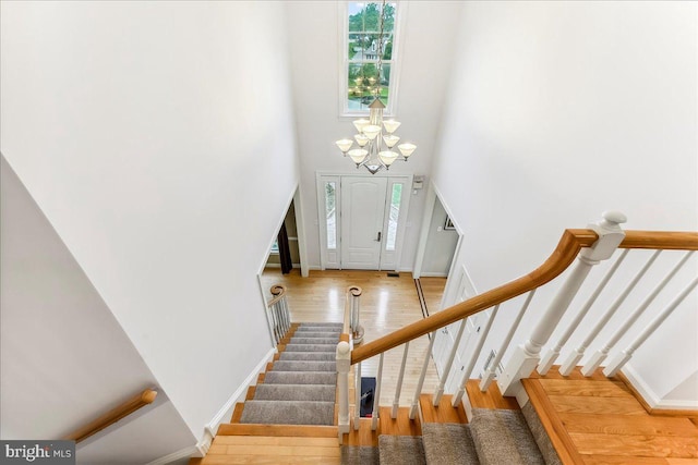 926 Kenmara Dr, West Chester, PA 19380 - staircase featuring a high ceiling, wood finished floors, and a chandelier
