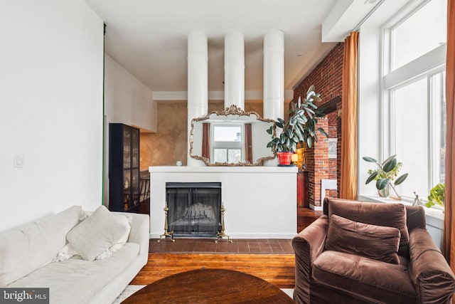 765 S 2nd St Unit G, Philadelphia, PA 19147 - living area with a fireplace with flush hearth, wood finished floors, and brick wall