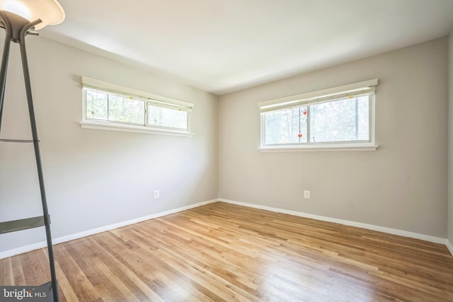 7826 Glenister Dr, Springfield, VA 22152 - unfurnished bedroom featuring multiple windows and wood finished floors