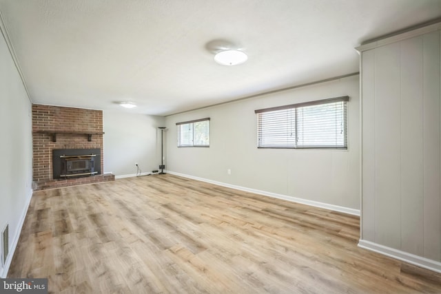 7826 Glenister Dr, Springfield, VA 22152 - unfurnished living room featuring light wood-type flooring and a brick fireplace