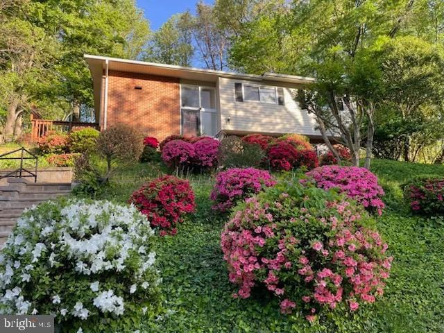 7826 Glenister Dr, Springfield, VA 22152 - view of side of home featuring a wooden deck and brick siding