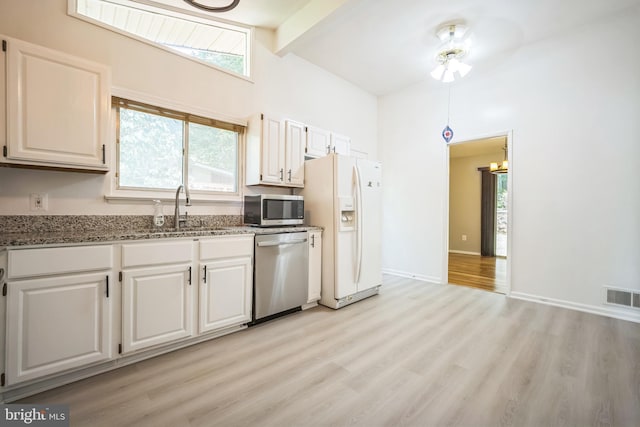 7826 Glenister Dr, Springfield, VA 22152 - kitchen with stainless steel appliances, beam ceiling, light wood finished floors, dark stone countertops, and high vaulted ceiling