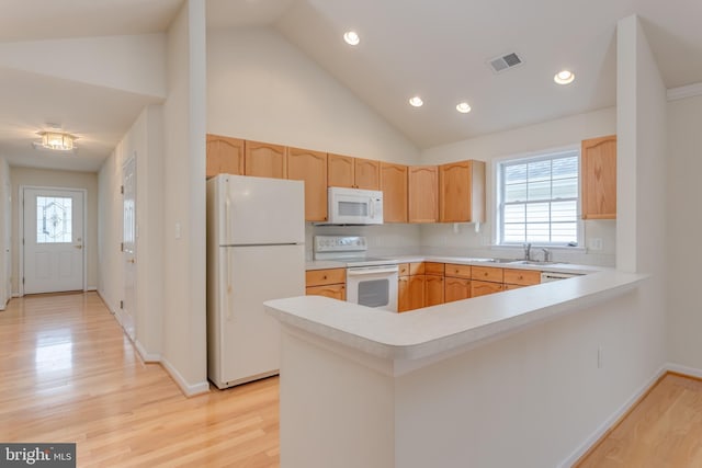 1826 Kershaw Ln, Winchester, VA 22601 - kitchen featuring white appliances, light brown cabinetry, a peninsula, light countertops, and high vaulted ceiling