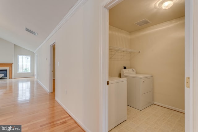 1826 Kershaw Ln, Winchester, VA 22601 - laundry room featuring a glass covered fireplace, light wood finished floors, and ornamental molding