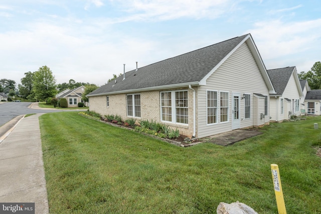 1826 Kershaw Ln, Winchester, VA 22601 - view of home's exterior featuring a shingled roof, brick siding, and a lawn