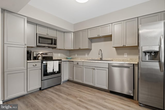 65 Petersburg Ln, Duncannon, PA 17020 - kitchen with stainless steel appliances, gray cabinets, light wood finished floors, and light stone counters