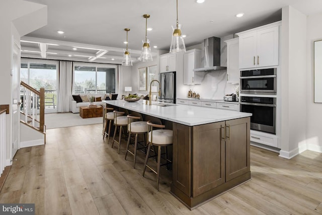 43786 Metro Ter Unit 1026A, Ashburn, VA 20147 - kitchen featuring wall chimney exhaust hood, recessed lighting, appliances with stainless steel finishes, coffered ceiling, and a large island with sink