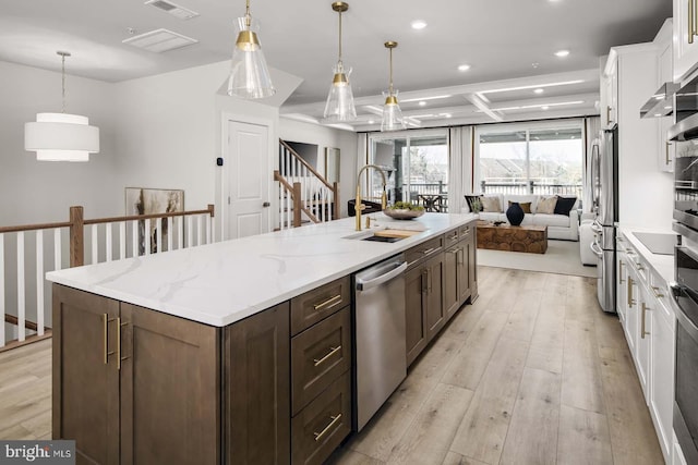 43786 Metro Ter Unit 1026A, Ashburn, VA 20147 - kitchen with appliances with stainless steel finishes, white cabinetry, light wood-type flooring, recessed lighting, and open floor plan