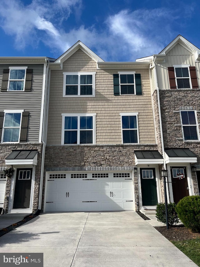 135 Burkwood Ter, Lake Frederick, VA 22630 - townhome / multi-family property featuring concrete driveway, a garage, and stone siding