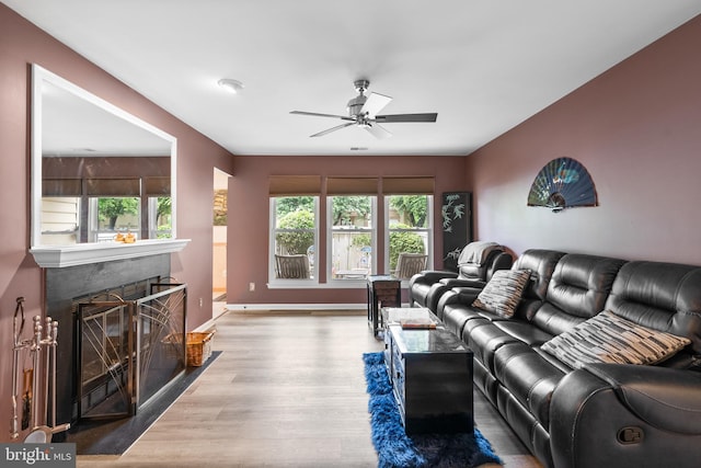 20103 Halethorpe Ln Unit 130, Germantown, MD 20876 - living room with wood finished floors, a ceiling fan, plenty of natural light, and a glass covered fireplace