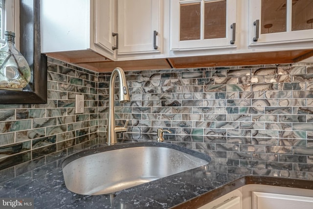 11 Sunset Ln, Bridgeton, NJ 08302 - kitchen view of decorative backsplash, white cabinetry, glass insert cabinets, and dark stone counters