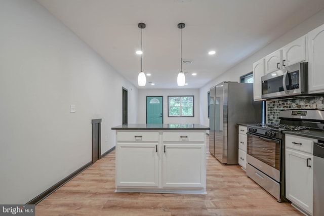 11 Sunset Ln, Bridgeton, NJ 08302 - kitchen featuring stainless steel appliances, dark countertops, white cabinetry, a center island, and decorative backsplash