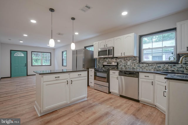 11 Sunset Ln, Bridgeton, NJ 08302 - kitchen featuring stainless steel appliances, dark countertops, tasteful backsplash, light wood-type flooring, and a center island