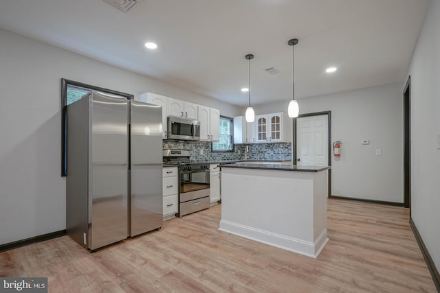 11 Sunset Ln, Bridgeton, NJ 08302 - kitchen with appliances with stainless steel finishes, white cabinetry, dark countertops, backsplash, and light wood-style floors