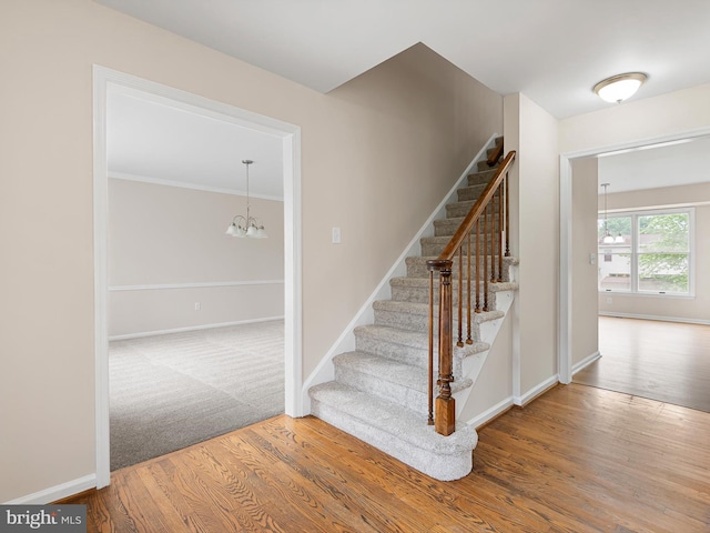 8 Taylors Farm Dr, Newark, DE 19711 - stairs featuring wood finished floors, a chandelier, and ornamental molding