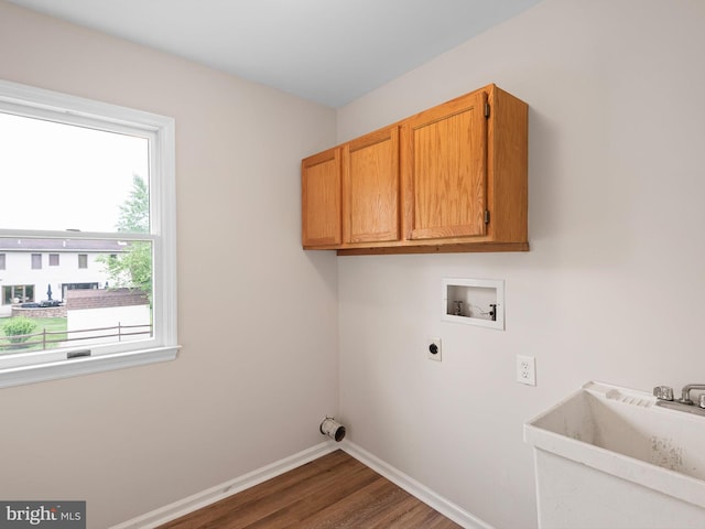 8 Taylors Farm Dr, Newark, DE 19711 - laundry room with washer hookup, electric dryer hookup, dark wood-type flooring, and cabinet space