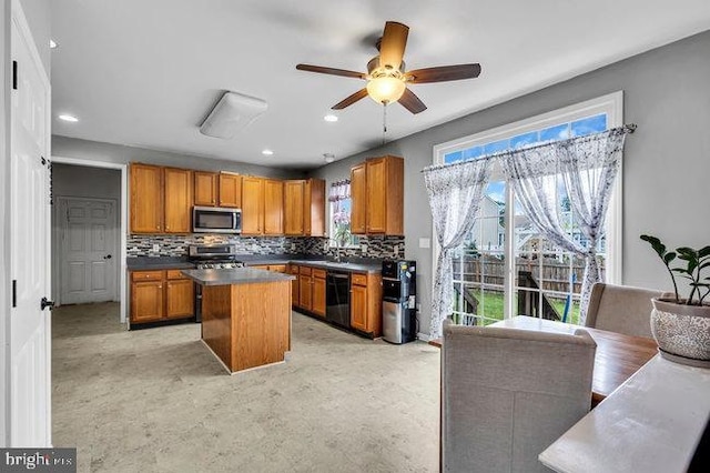 30 Homestead Dr, Pemberton, NJ 08068 - kitchen with stainless steel appliances, brown cabinetry, backsplash, a kitchen island, and a ceiling fan