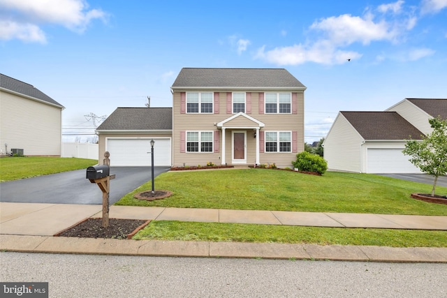 355 Old Stone Way, York, PA 17406 - colonial home featuring asphalt driveway, a front lawn, and an attached garage
