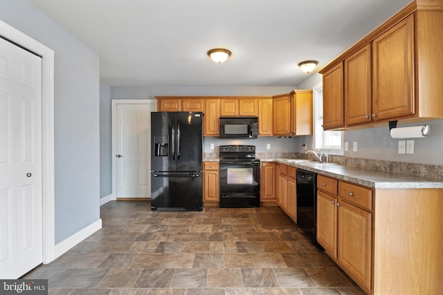 355 Old Stone Way, York, PA 17406 - kitchen featuring black appliances, stone finish flooring, and brown cabinetry