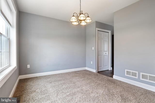 355 Old Stone Way, York, PA 17406 - unfurnished room with dark carpet, a chandelier, and healthy amount of natural light
