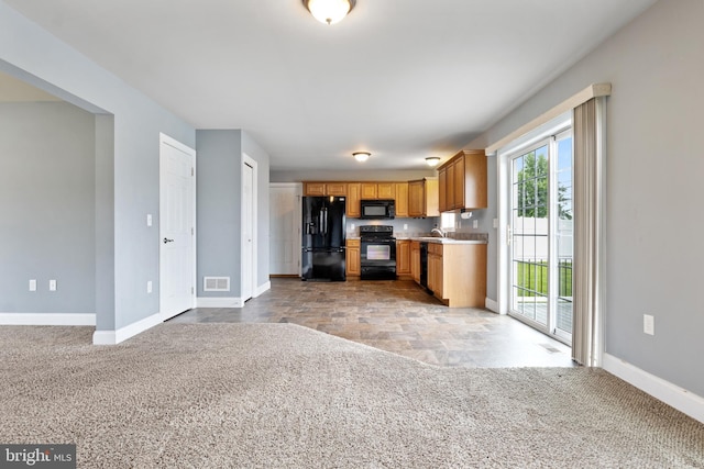 355 Old Stone Way, York, PA 17406 - kitchen with black appliances, light countertops, light colored carpet, and open floor plan
