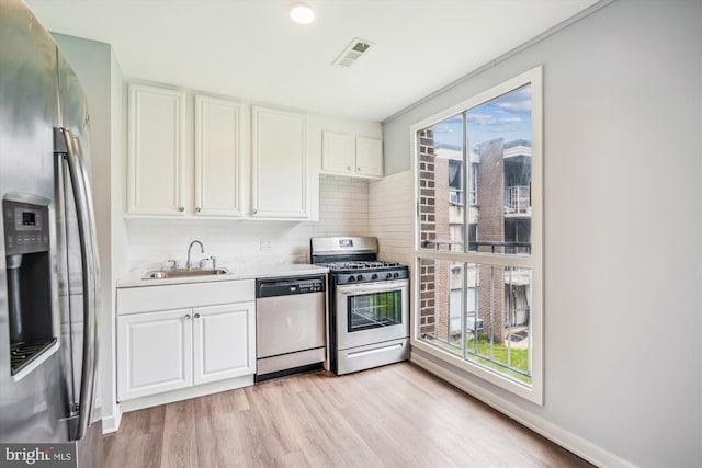 7985 Riggs Rd Unit 5, Hyattsville, MD 20783 - kitchen featuring appliances with stainless steel finishes, healthy amount of natural light, backsplash, and light countertops