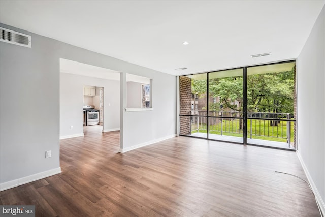 7985 Riggs Rd Unit 5, Hyattsville, MD 20783 - empty room with wood finished floors and a wall of windows