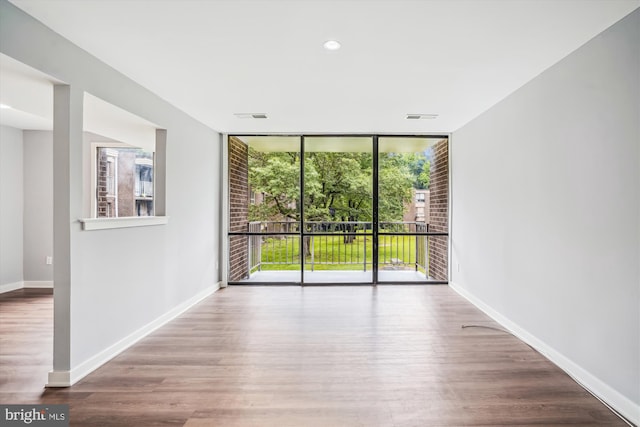 7985 Riggs Rd Unit 5, Hyattsville, MD 20783 - spare room featuring expansive windows, wood finished floors, and recessed lighting