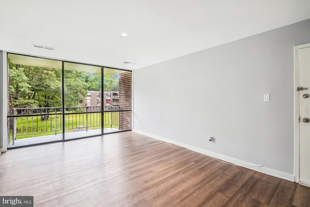 7985 Riggs Rd Unit 5, Hyattsville, MD 20783 - empty room featuring wood finished floors and a wall of windows