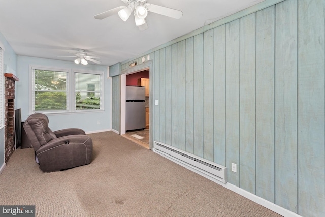150 Coolidge Ave, Lawrence Township, NJ 08648 - living area with a baseboard radiator, carpet, a ceiling fan, a fireplace, and wood walls