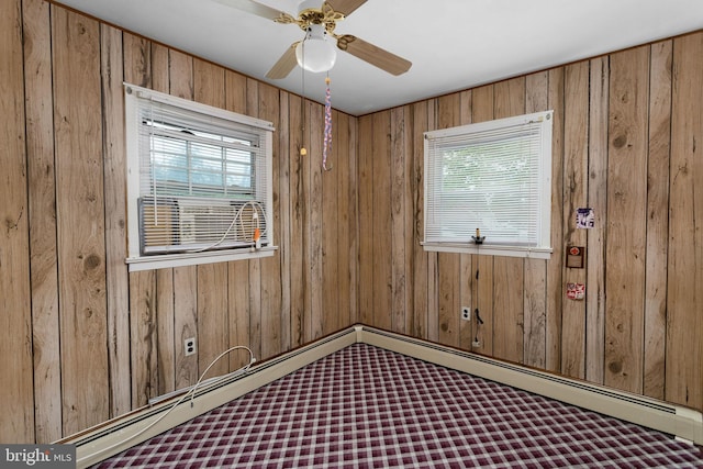 150 Coolidge Ave, Lawrence Township, NJ 08648 - carpeted empty room featuring wooden walls, healthy amount of natural light, and a ceiling fan