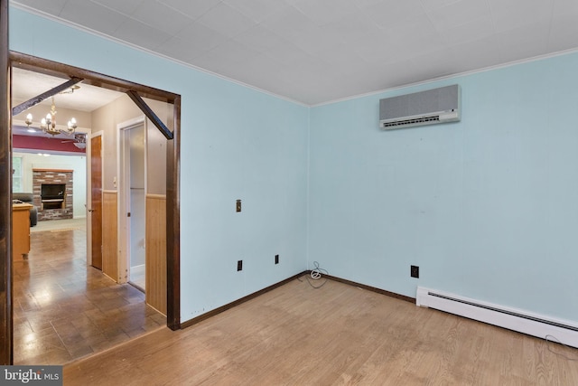 150 Coolidge Ave, Lawrence Township, NJ 08648 - empty room with a wall mounted air conditioner, a baseboard heating unit, a chandelier, crown molding, and wood finished floors